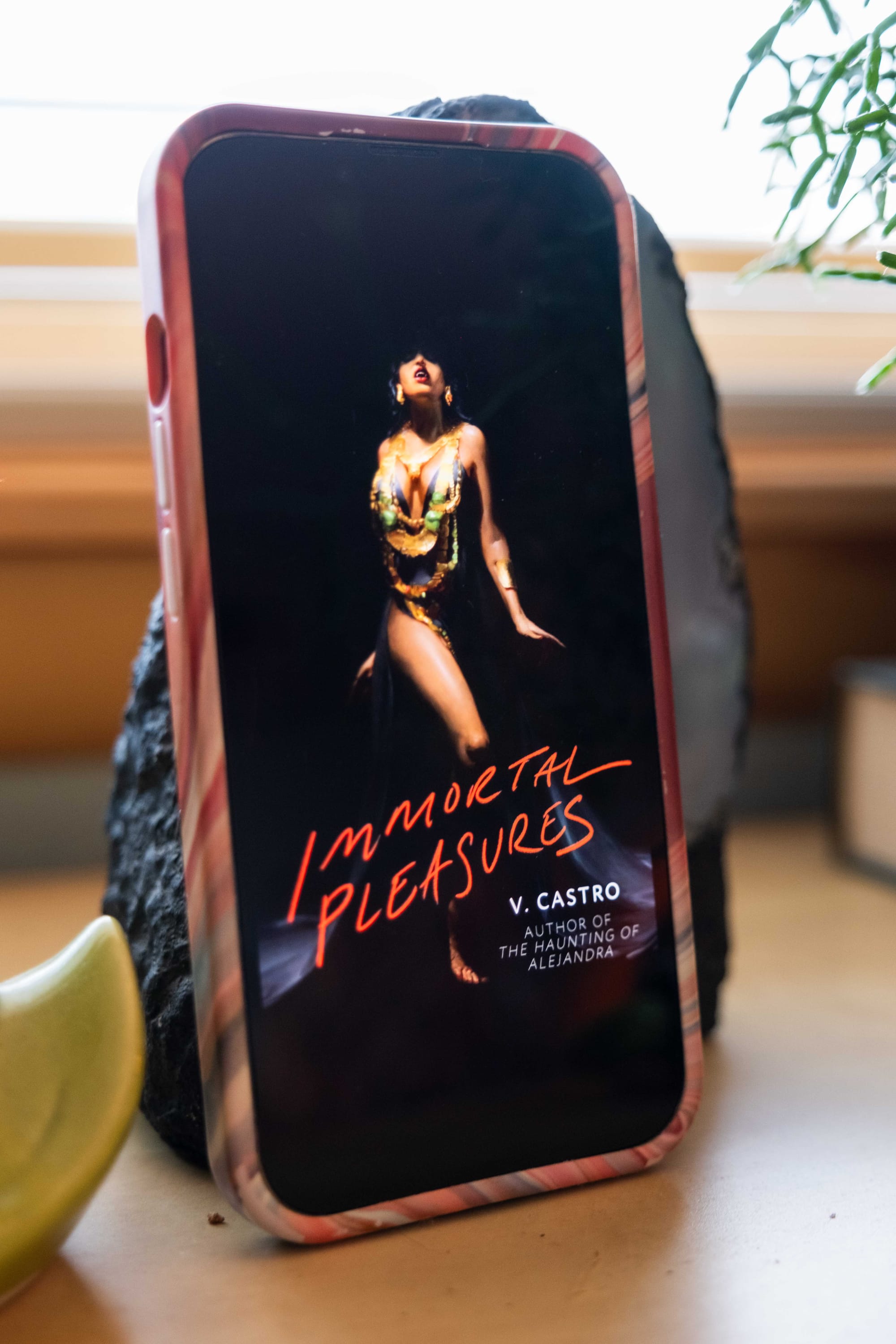 Book cover for Immortal Pleasures by V. Castro on an iPhone