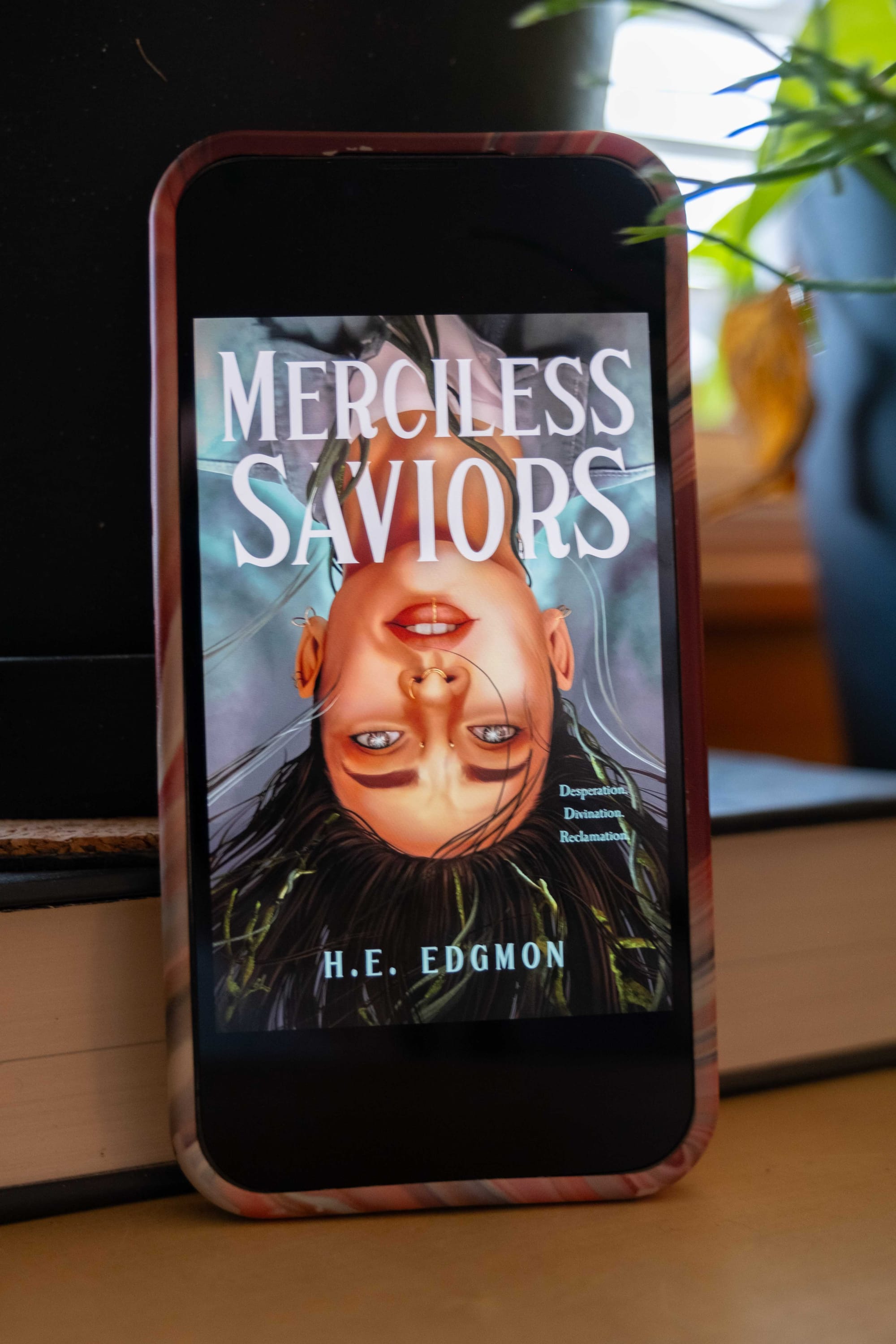 Book cover for Merciless Saviors by H. E. Edgmon on an iPhone