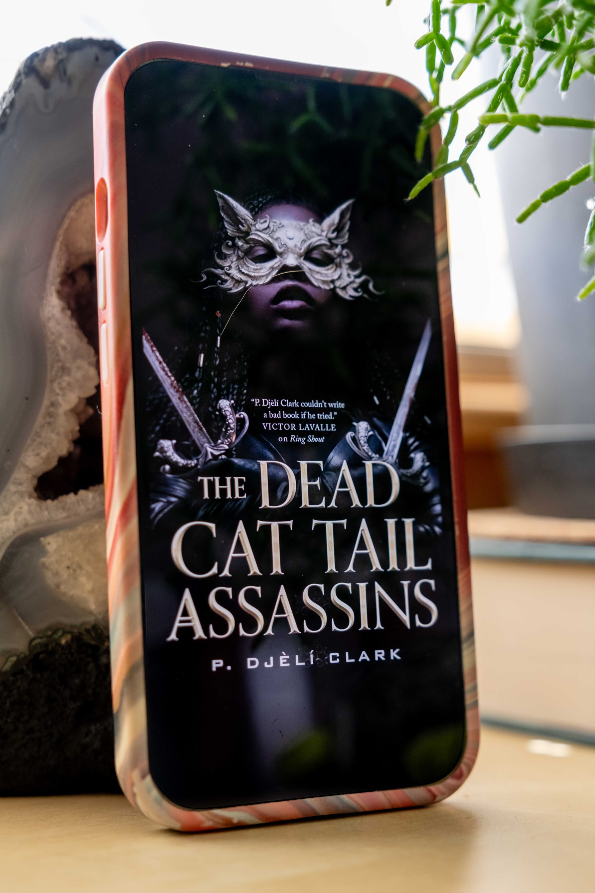 Book cover for The Dead Cat Tail Assassins by P. Djèlí Clark on an iPhone