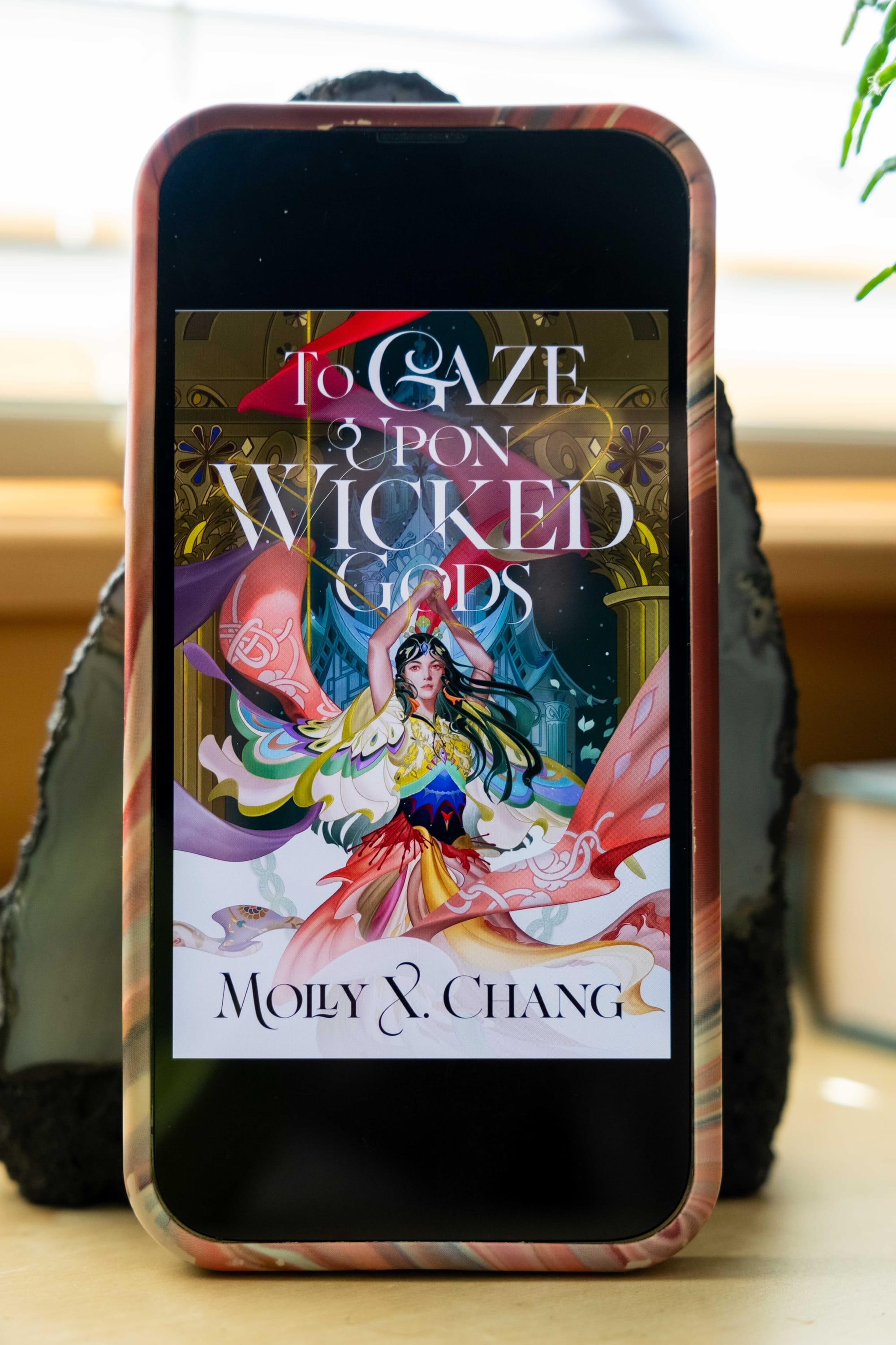 Book cover for To Gaze Upon Wicked Gods by Molly X. Chang on an iPhone
