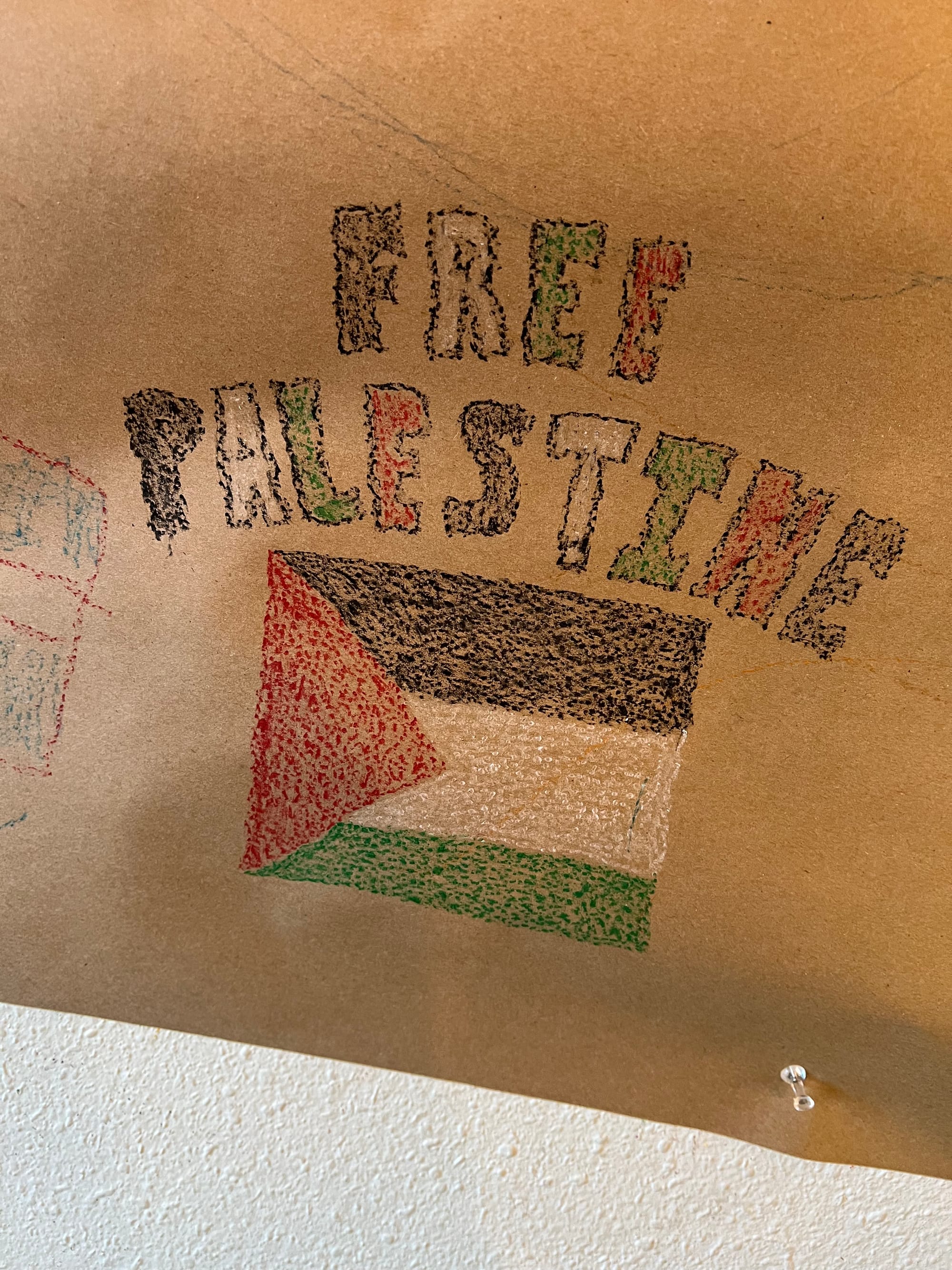 Free Palestine and a Palestinian flag drawn on paper